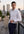 Man in a white shirt standing on a rooftop deck with city skyline in the background