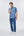 Man wearing a blue patterned shirt and jeans on a white background. Leo Chevalier 